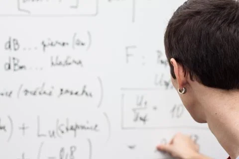 Thinking boy with whiteboard solving equation Stock Photos