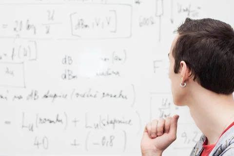Thinking boy with whiteboard solving equation Stock Photos