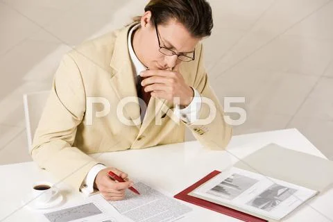 Thinking businessman reading the document Stock Photos