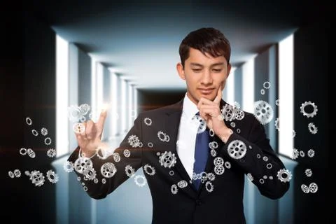 Thinking businessman touching cogs and wheels Illustrazione stock