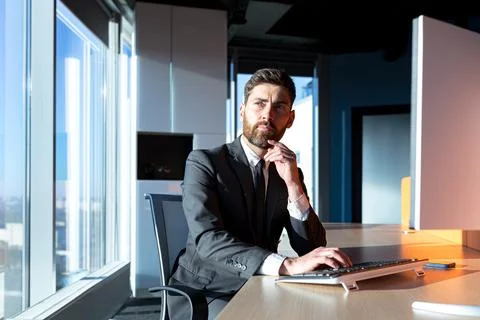 Thinking businessman working in the office at the computer, focused man in Stock Photos