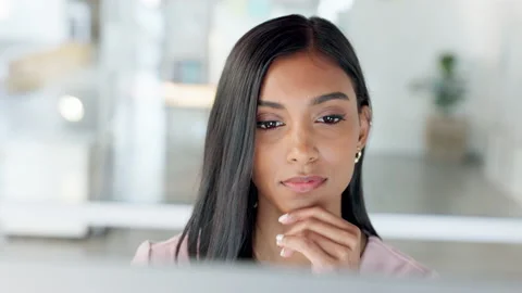 Thinking businesswoman working on a computer desktop analyzing social media Stock Footage 203809014