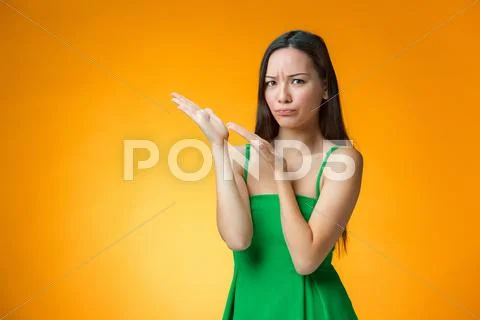 The thinking Chinese girl on yellow background Stock Photos