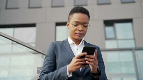 Thinking confident business african american woman uses mobile phone smartphone  Stock Footage