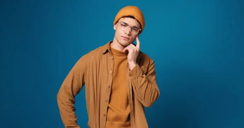 Thinking, confused and face of man with doubt in studio isolated on blue Stock Footage 314368687