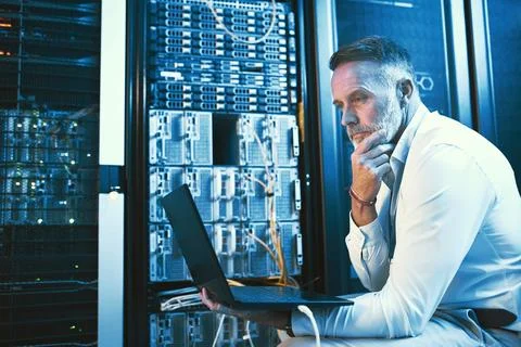 Thinking, engineer and man with laptop in server room, online and Stock Photos
