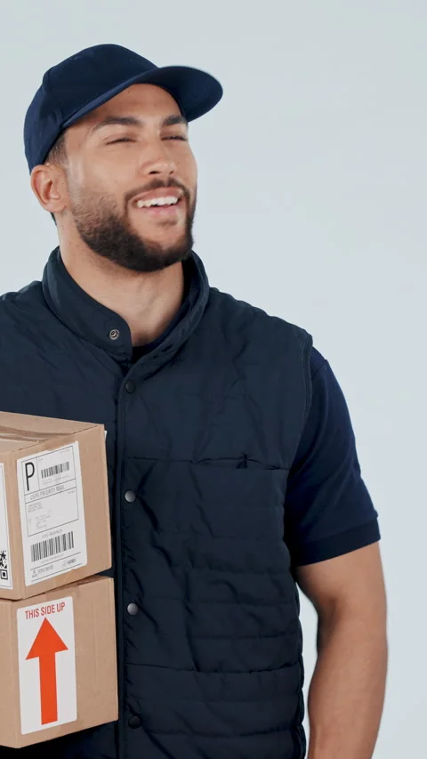 Thinking, face and delivery man in studio with boxes, package and confident for Stock Footage 337022997