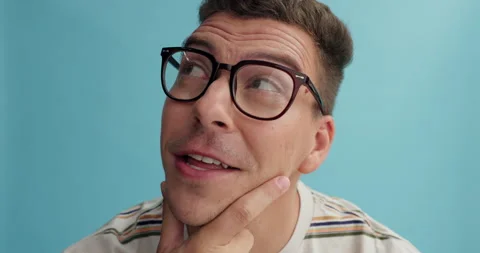 Thinking, face and man with glasses in studio for brainstorming, problem solving Stock Footage 264468162