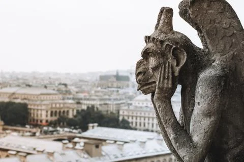 Thinking figure called Chimera or grotesque in Paris France from Bell tower of Stock Photos