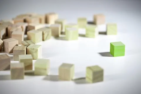 Thinking Green, even a single one can bring about change, green wooden cube Stock Photos