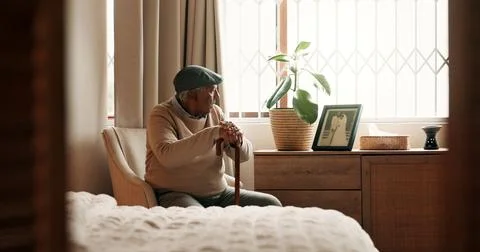 Thinking, grief or old man in house with walking stick, mourning or memory .. Stock Photos