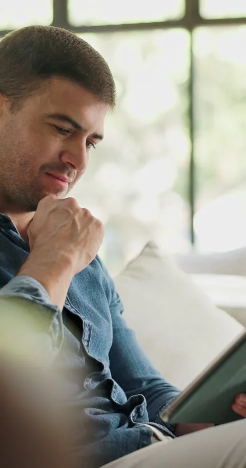 Thinking, home or man on sofa, tablet for magazine submission or ideas for Stock Footage 330922308