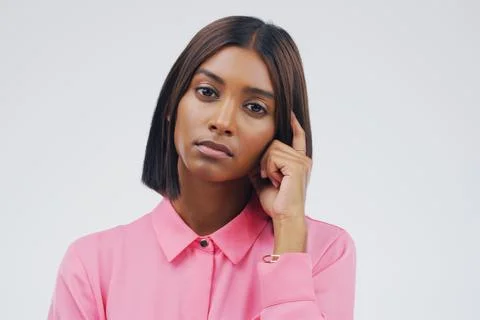 Thinking, idea and portrait of Indian woman with doubt in studio for Stock Photos