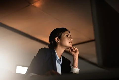 Thinking, ideas and problem solving at night, woman in office reading email or Stock Photos