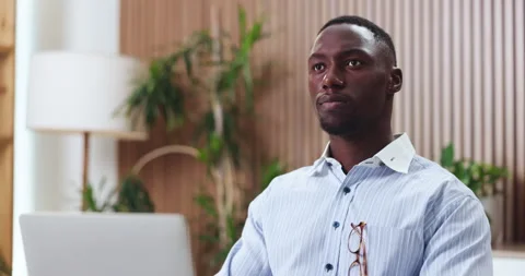 Thinking, insight or black man in firm with laptop, problem solving or funding Stock Footage 330044802