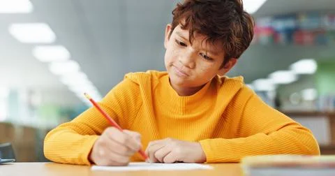 Thinking, learning and kid writing on paper for exam, test or problem solving 写真素材