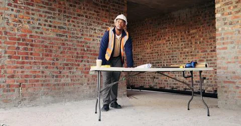 Thinking, man and construction worker with blueprint on site with planning for Stock Photos