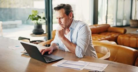 Thinking, man and reading at house with laptop, research and finance report.. Stock Photos