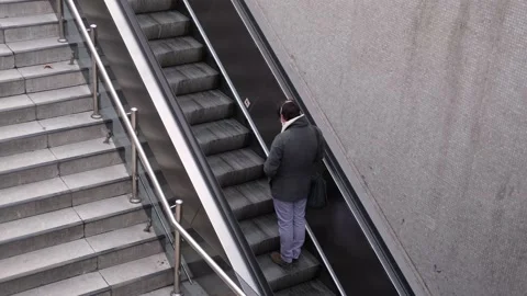 Thinking man climbs the escalator Stock Footage 146291282