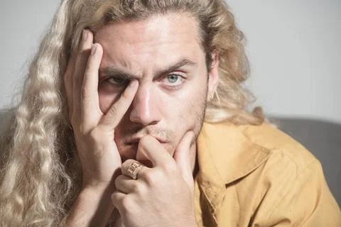 Thinking man with hand on face. Close-up of young man deep in think. Thinking Stock Photos