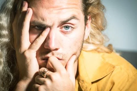 Thinking man with hand on face. Close-up of young man deep in think. Thinking Stock Photos