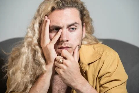 Thinking man with hand on face. Close-up of young man deep in think. Thinking Stock Photos
