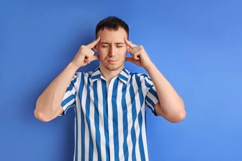 Thinking man isolated on blue background. Pensive male concentrated on thoughts Stock Photos