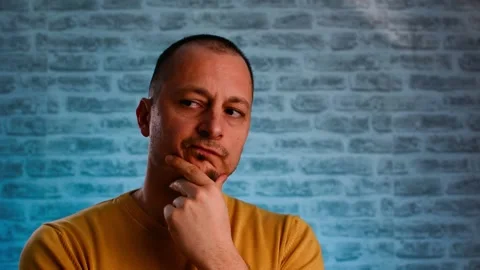 Thinking man looking up and around on neon blue background. Stock Footage 147948274