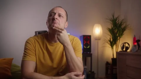 Thinking man looking up and around in his living room. Stock Footage 269990243