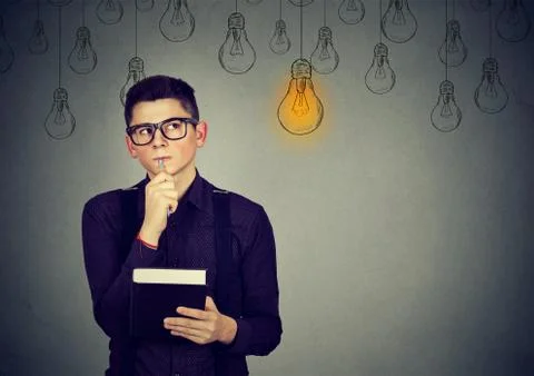 Thinking man looking up with light idea bulb above head . Stock Photos