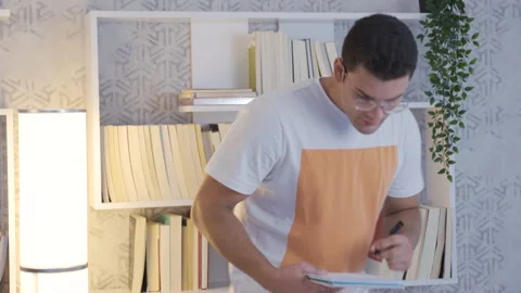 Thinking man with notebook pen in hand. 스톡 동영상 220170133