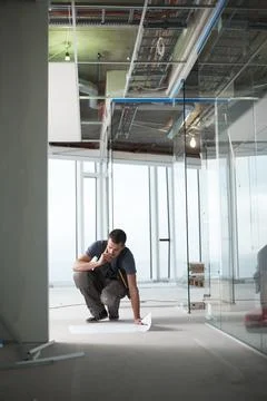 Thinking, man or builder at construction site with floor plan for building draft Stock Photos