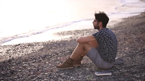 Thinking man relaxing on the beach Stock Footage 58246080