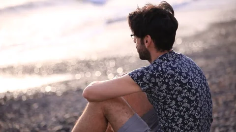 Thinking man relaxing on the beach Stock Footage 58250370