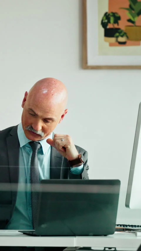 Thinking, mature and man in office on computer with business review, research or Stock Footage 335353573