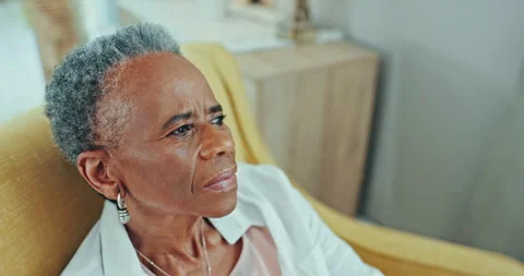 Thinking, nostalgia and sad senior black woman in a chair with memory or Stock Footage 254855152