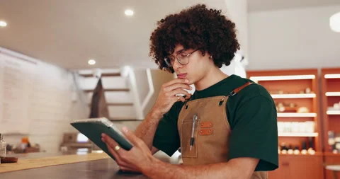 Thinking, owner and man at restaurant with tablet, menu development and planning Stock Footage 335938987