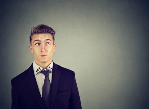 Thinking perplexed man wondering looking up solving a problem 스톡 사진