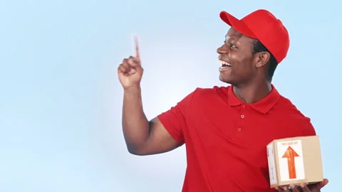 Thinking, pointing and black man with delivery box, package and parcel on blue Stock Footage 251784276