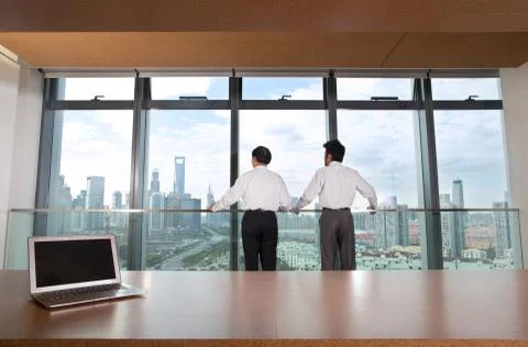 Thinking Portrait Three-quarters long. Shanghai Two people. Workplace Window Stock Photos