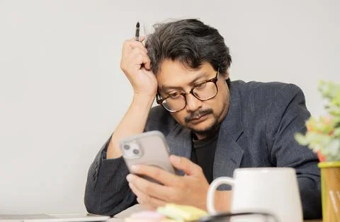 Thinking, problem solving and business man using smartphone in office worki.. Stock Photos