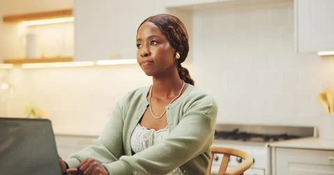 Thinking, remote work and black woman with laptop in kitchen, ebook inspira.. Stockfoto's