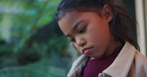 Thinking, sad and child by window in home with reflection of trauma, bad memory Stock Footage 336702869