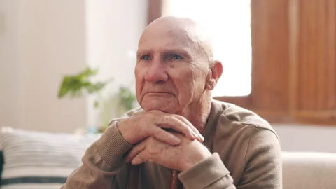 Thinking, sad and senior man on sofa in home with memories, nostalgia and Stock Footage 254834823