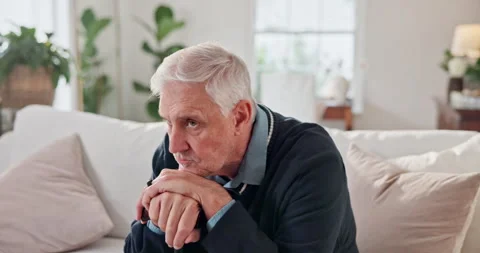 Thinking, sad and senior man on home sofa with regret, walking stick or Stock Footage 337630608
