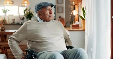 Thinking, sad or old man in house with wheelchair, loss or memory of past m.. Stock Photos
