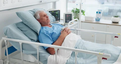 Thinking, senior man and worry in hospital bed for bad news, medical mistake and Stock Footage 321831998