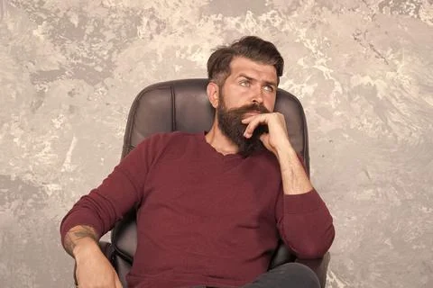 Thinking on serious problem. Serious hipster relax in chair. Serious look of Stock Photos