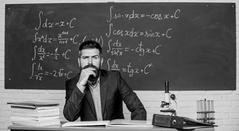 Thinking on serious problem. Serious teacher touching beard by hand. Bearded man Foto stock