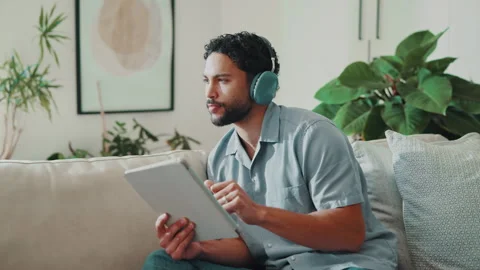 Thinking, tablet or man with headphones in home for playlist, streaming audio or Stock Footage 344250658